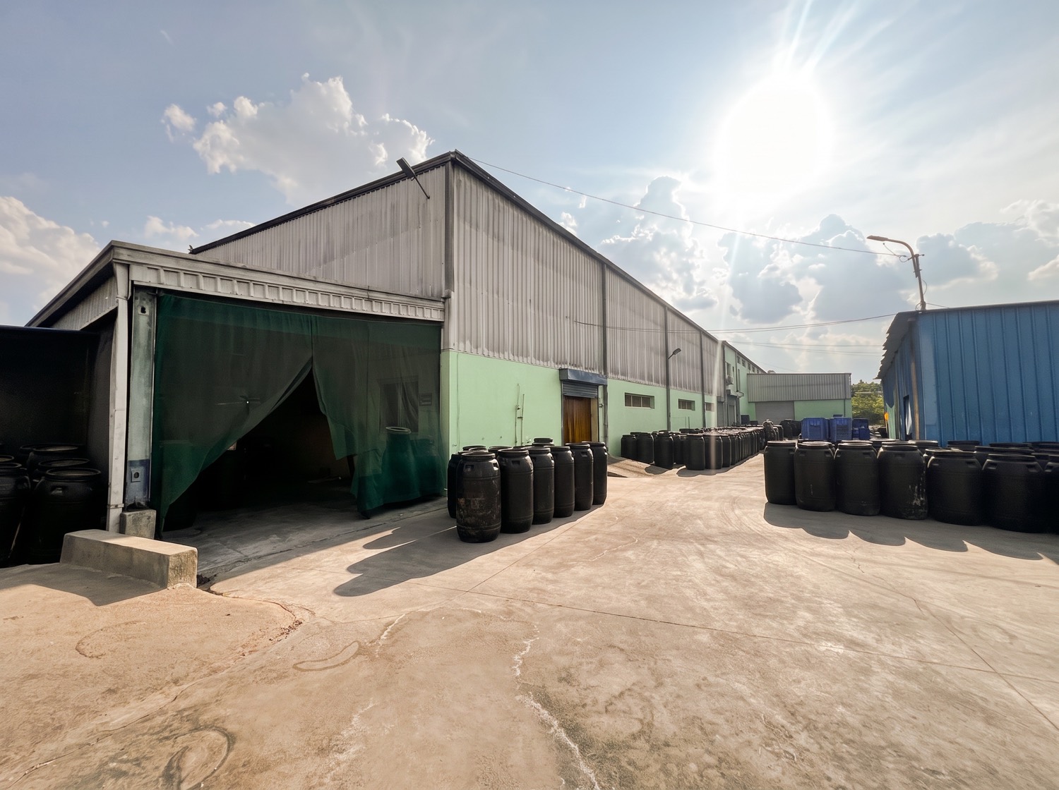 Manufacturing facility exterior with storage barrels